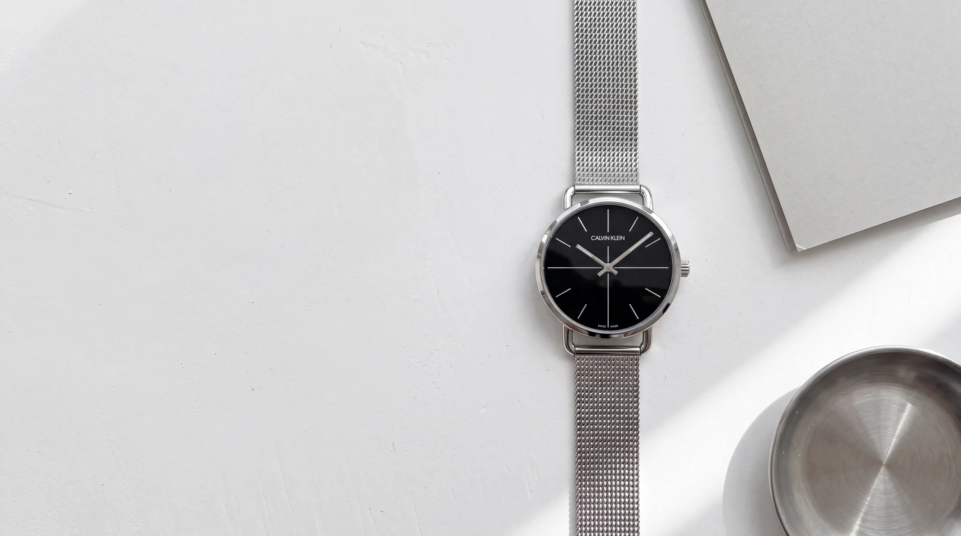 Calvin Klein Even K7B23121 women's steel watch, black dial crossed by a thin cross, Milanese mesh on white plaster